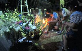 People light candles to pray for children killed at Osaka school